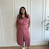 pink loose fitting tank top with brown buttons and pink loose fitting midi skirt with side slits with brown buttons on model standing wearing white sneakers