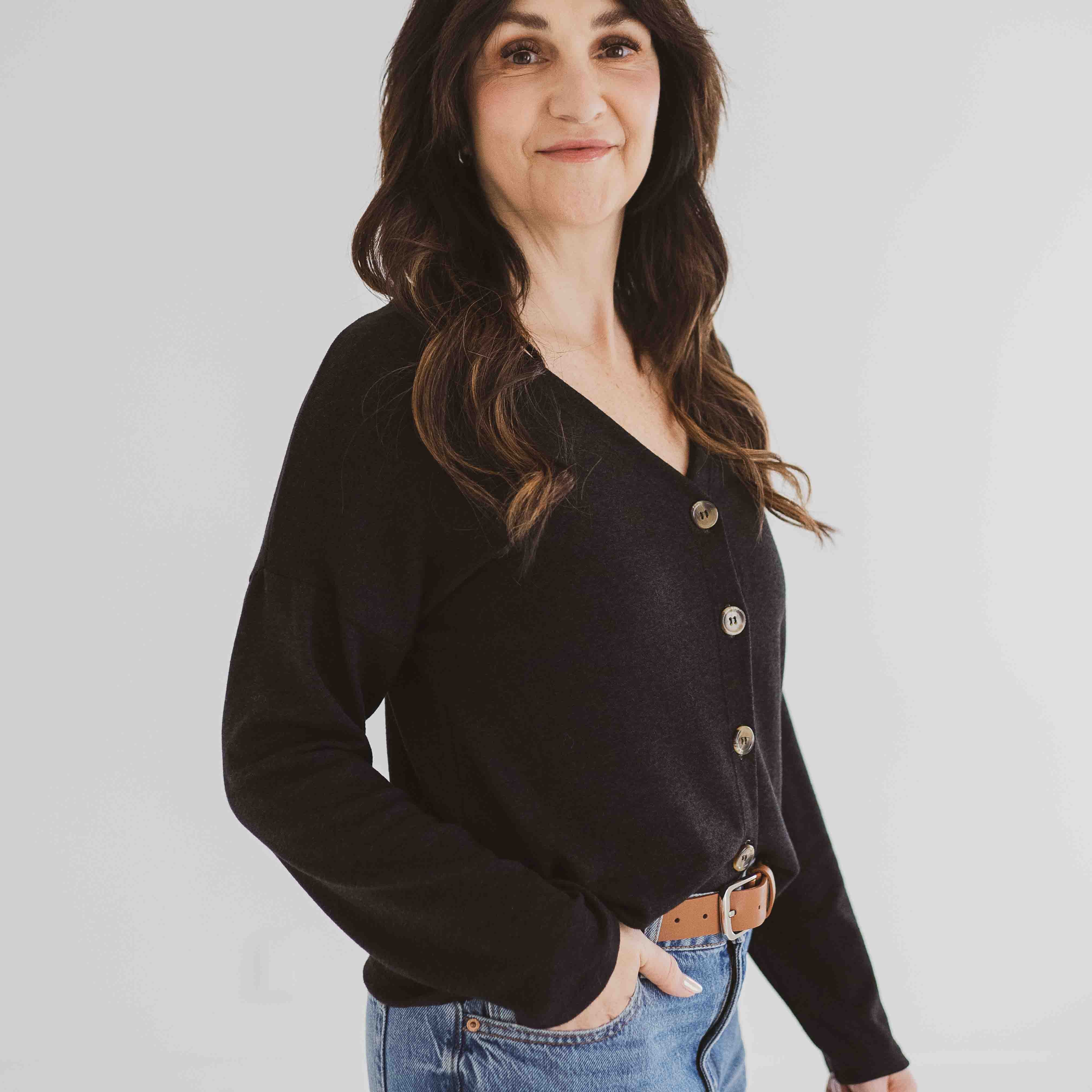 model angled wearing button up cardigan in black for women made in canada