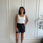 white square neck tank top and black leather shorts