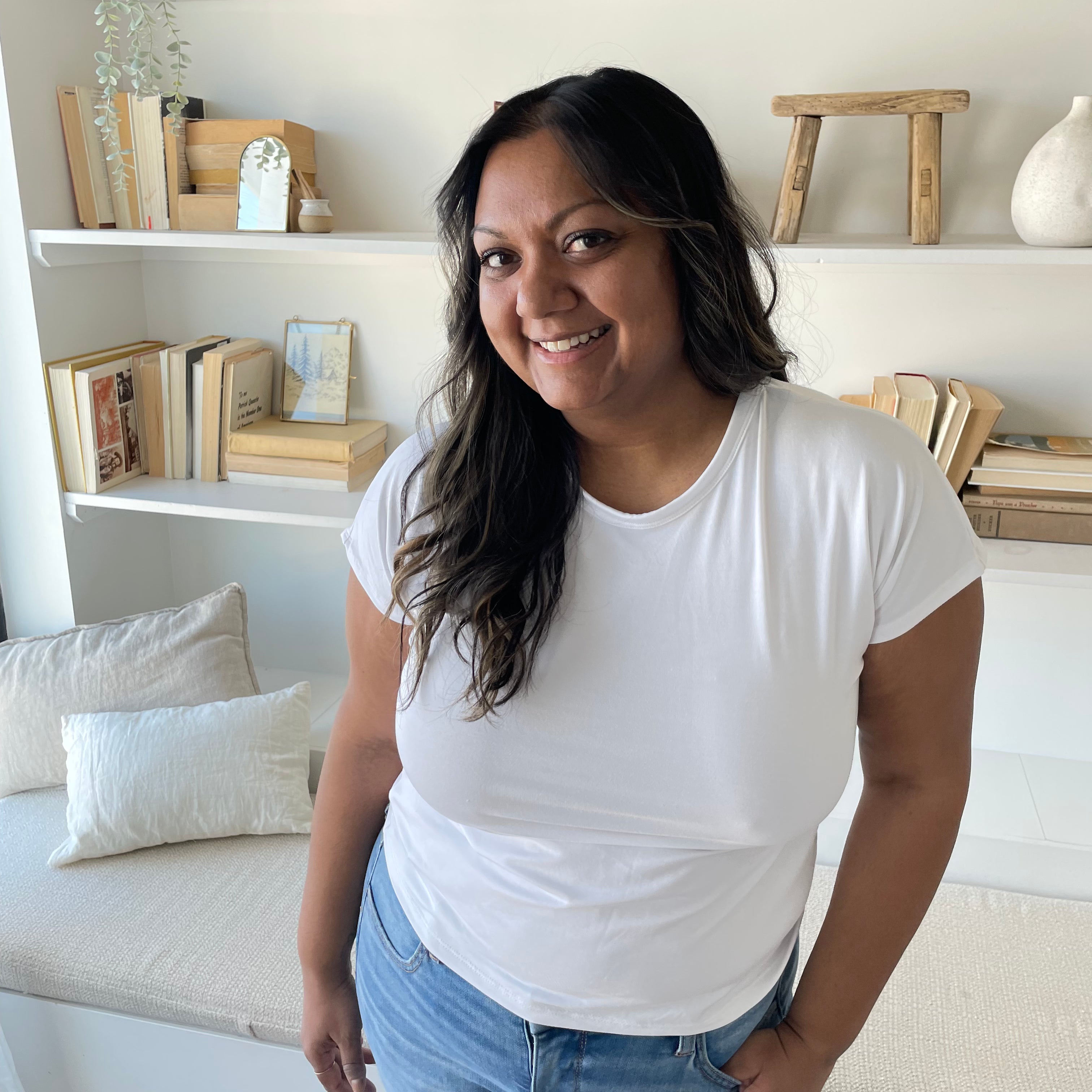 indian woman smiling wearing a white crewneck bamboo t-shirt and jeans