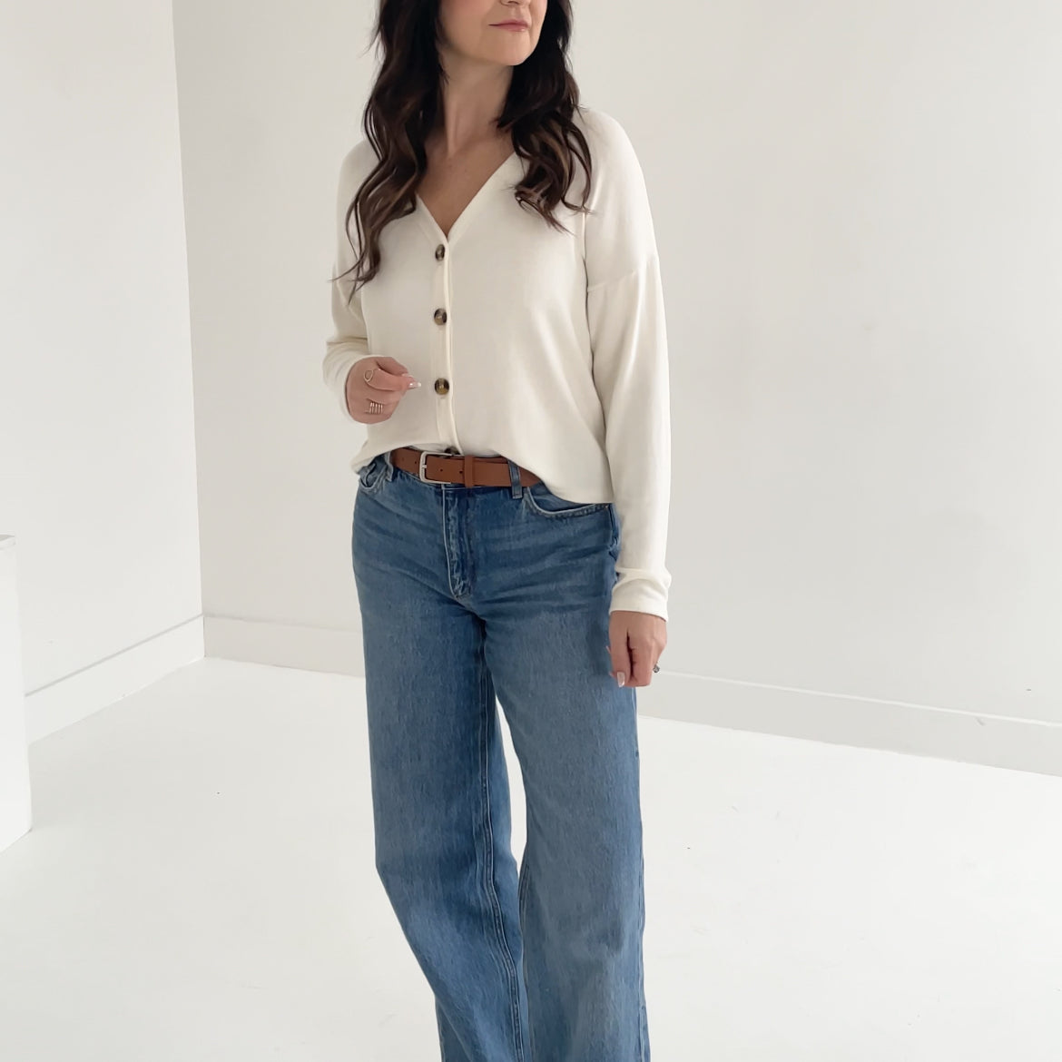 Model wearing oversized holly button up cream cardigan made in canada