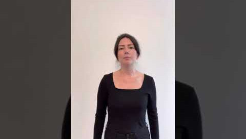 video of woman wearing black square neck top explaining the features