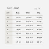 Ang Hill size chart table showing measurements for sizes XS through 2X, with columns for Size, Bust, Waist, and Hip on a light gray background.