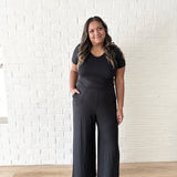 woman wearing black romper with wide leg pants and pockets