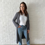 woman wearing long grey cardigan and white t-shirt