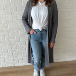 woman wearing long grey cardigan and white t-shirt