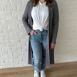 woman wearing long grey cardigan and white t-shirt