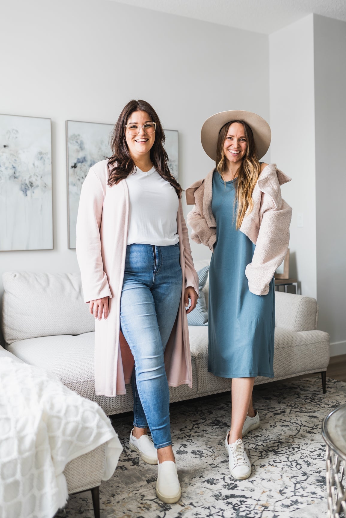 two women wearing long pink cardigan and white v-neck t-shirt and the other wearing a blue tank dress