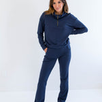 Woman wearing a navy blue bamboo lounge set on a white background. Clothing made in canada for women.