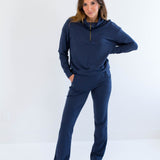 Woman wearing a navy blue bamboo lounge set on a white background. Clothing made in canada for women.