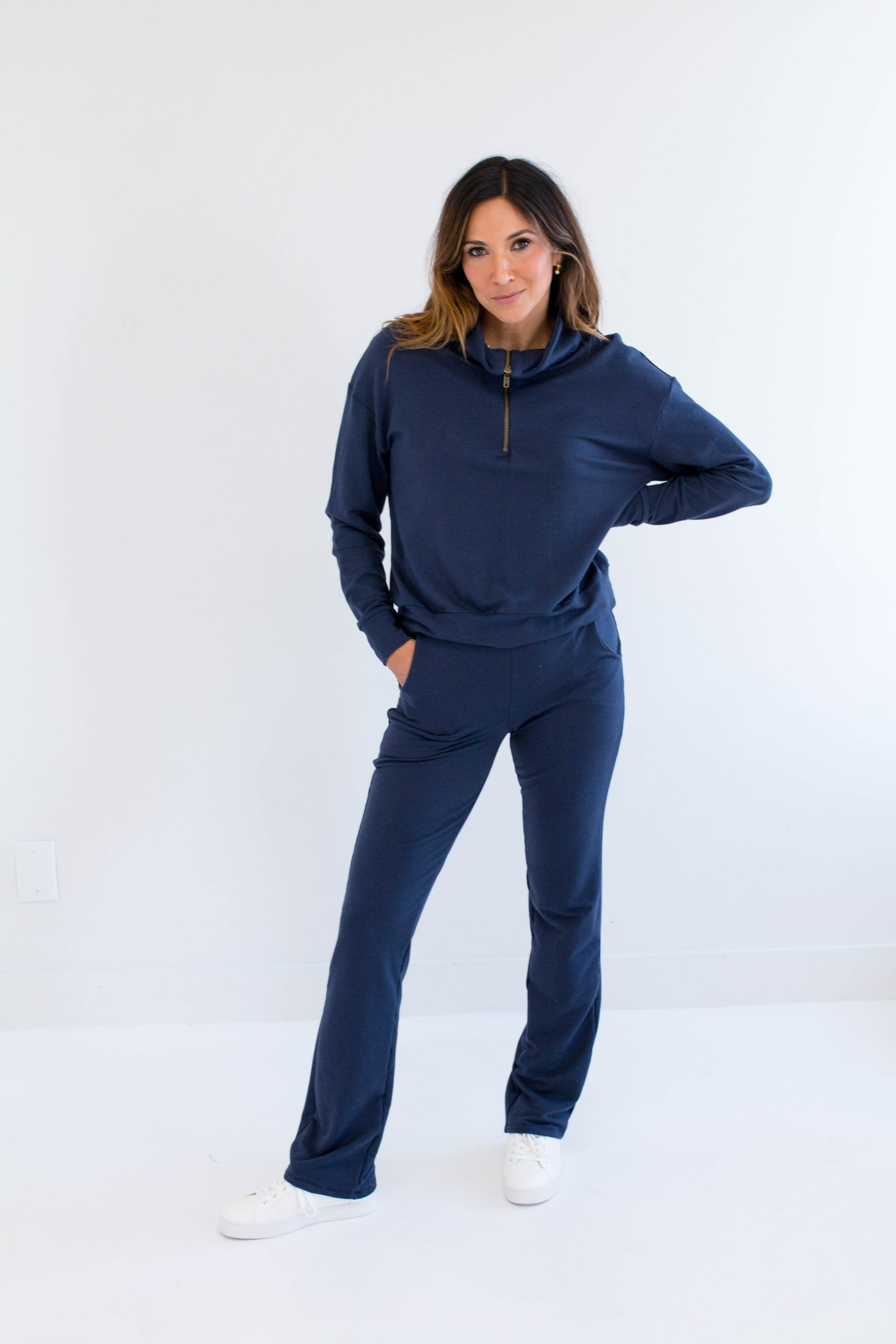 Woman wearing a navy blue bamboo lounge set on a white background. Clothing made in canada for women.