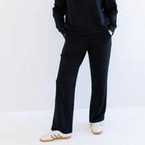 Woman wearing a black wide leg pants on a white background. Apparel made in canada