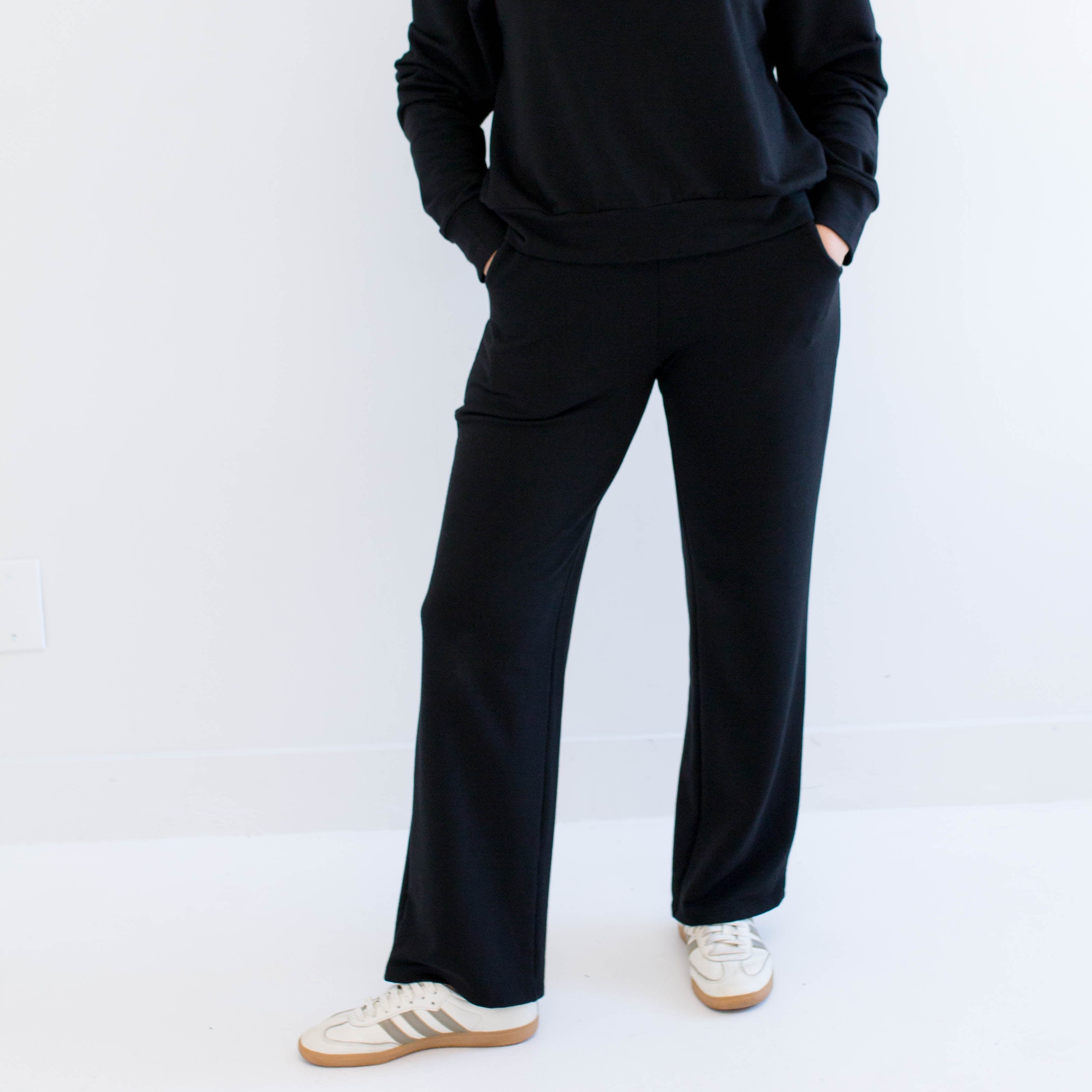 Woman wearing a black wide leg pants on a white background. Apparel made in canada