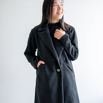 Black wool coat with one button. Wide collar knee length. Made in canada.