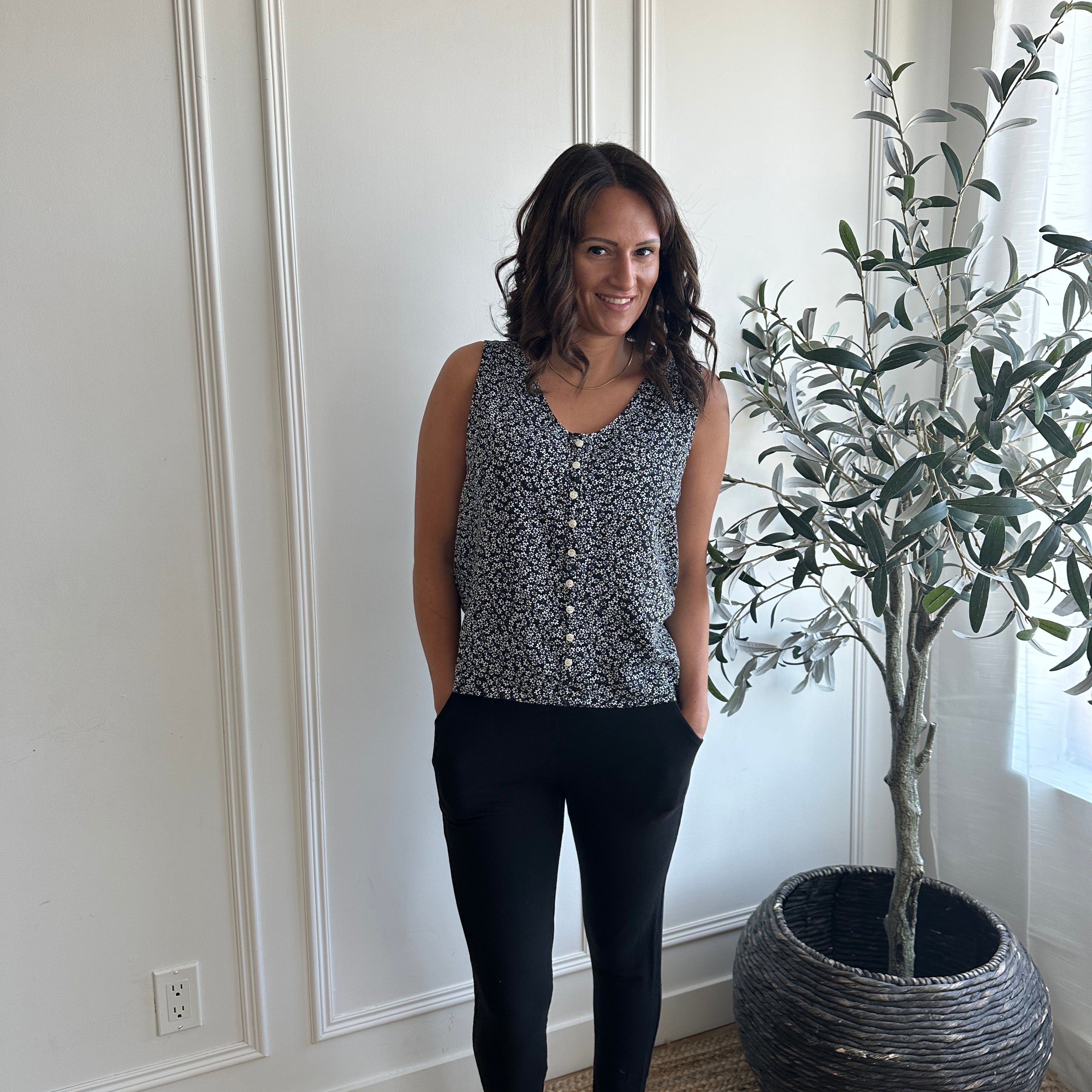 black and white floral loose fitting tank top with white buttons with black bamboo tapered joggers