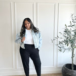 woman wearing jean jacket, white crewneck and black tapered joggers