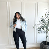 woman wearing jean jacket, white crewneck and black tapered joggers