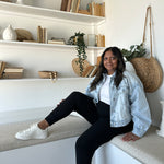 woman wearing white sneakers, jean jacket and black joggers