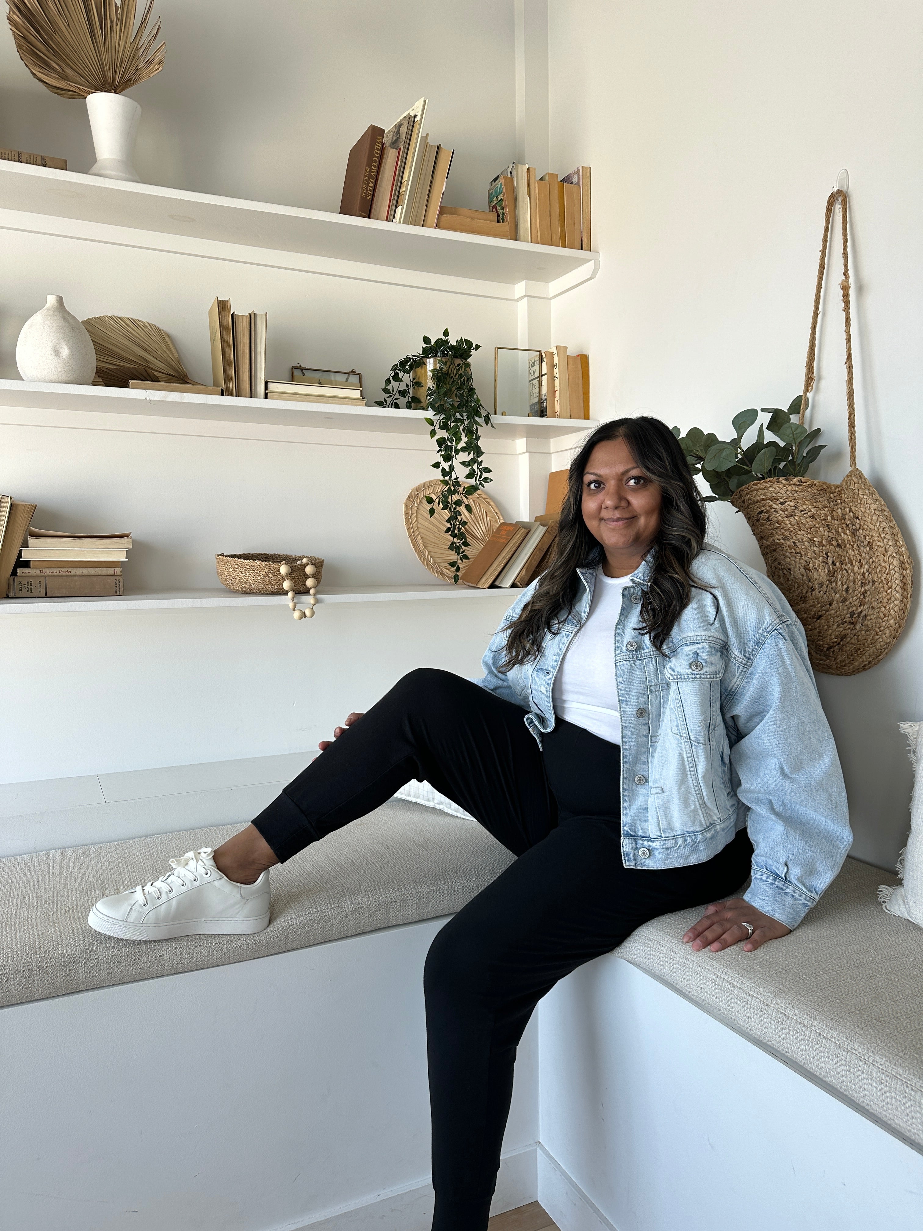 woman wearing white sneakers, jean jacket and black joggers