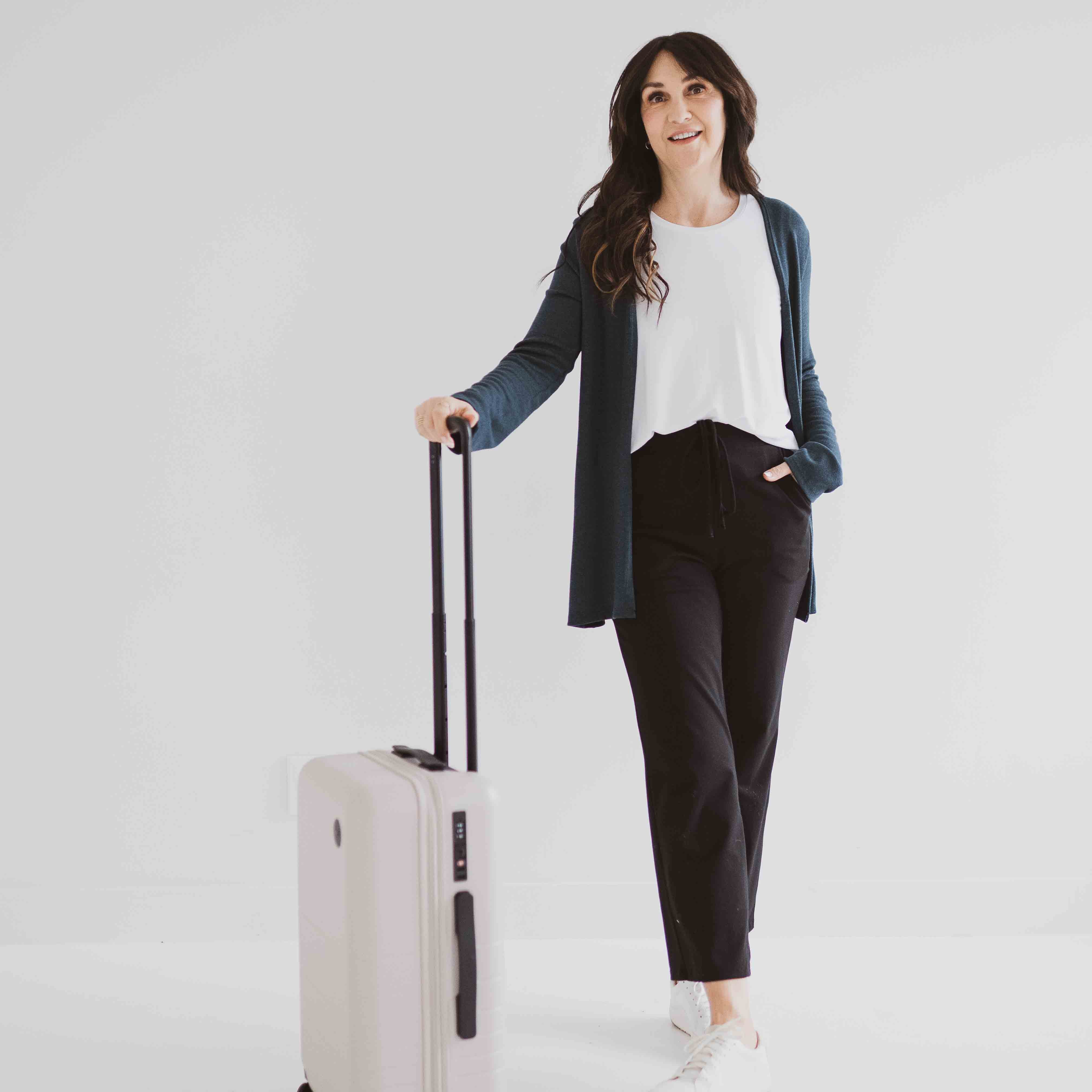travel outfit canada tank top womens white loose fitting paired with black cropped pants and teal cardigan - apparel made in canada