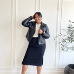 woman wearing black moto jacket, black midi skirt and crewneck t-shirt