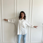 white oversized button up shirt with light wash denim