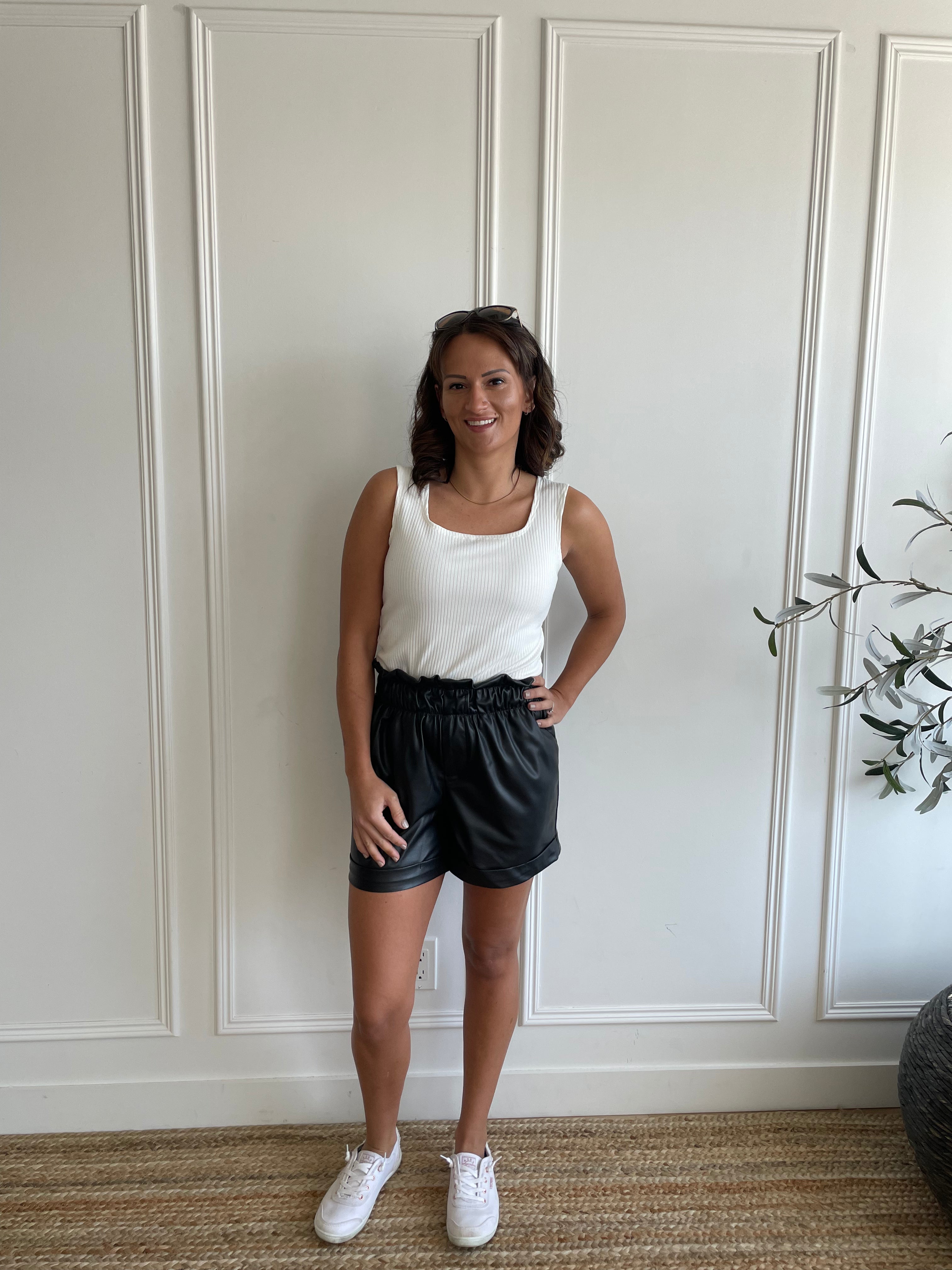 white square neck tank top and black leather shorts