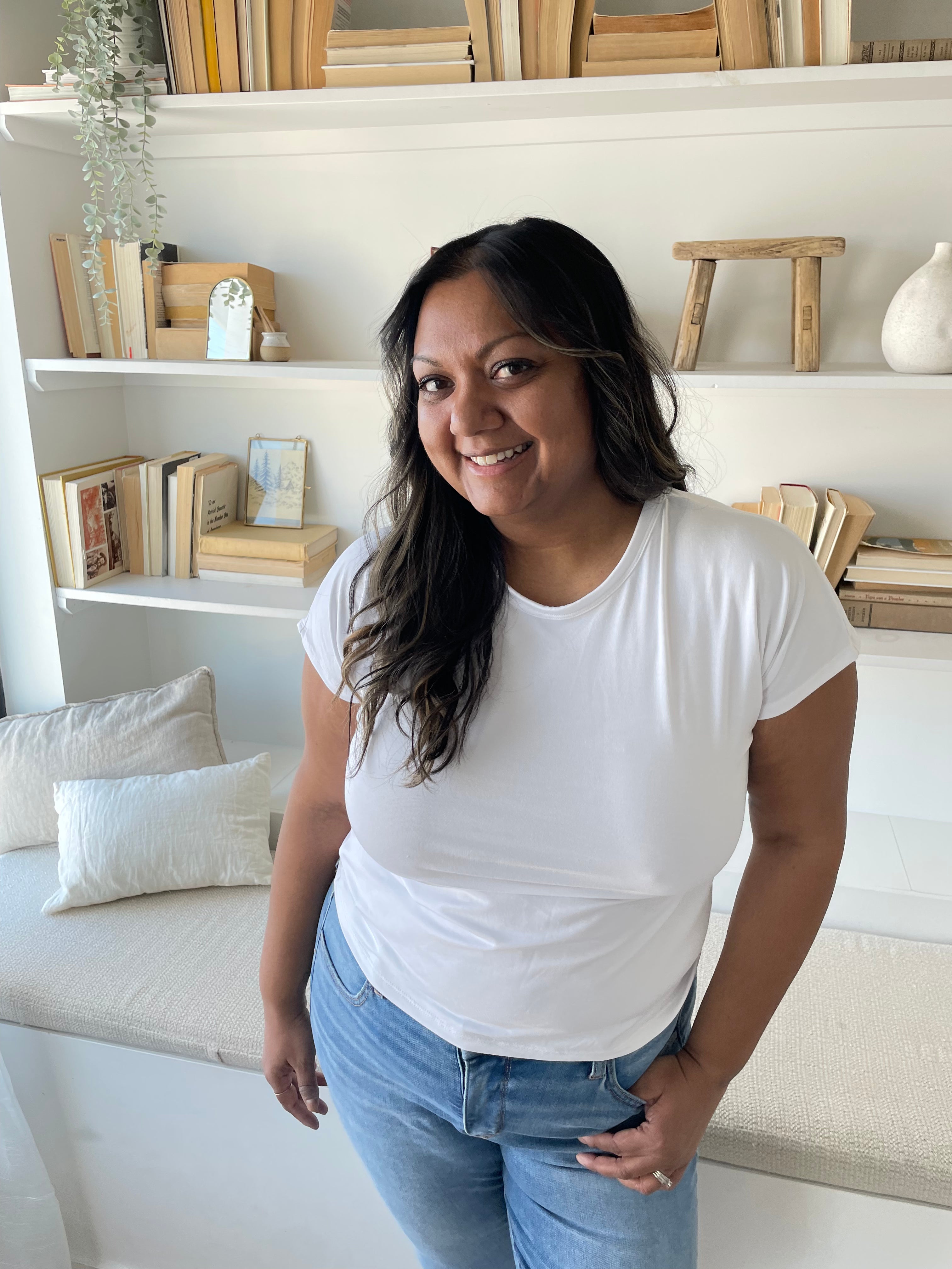 indian woman smiling wearing a white crewneck bamboo t-shirt and jeans