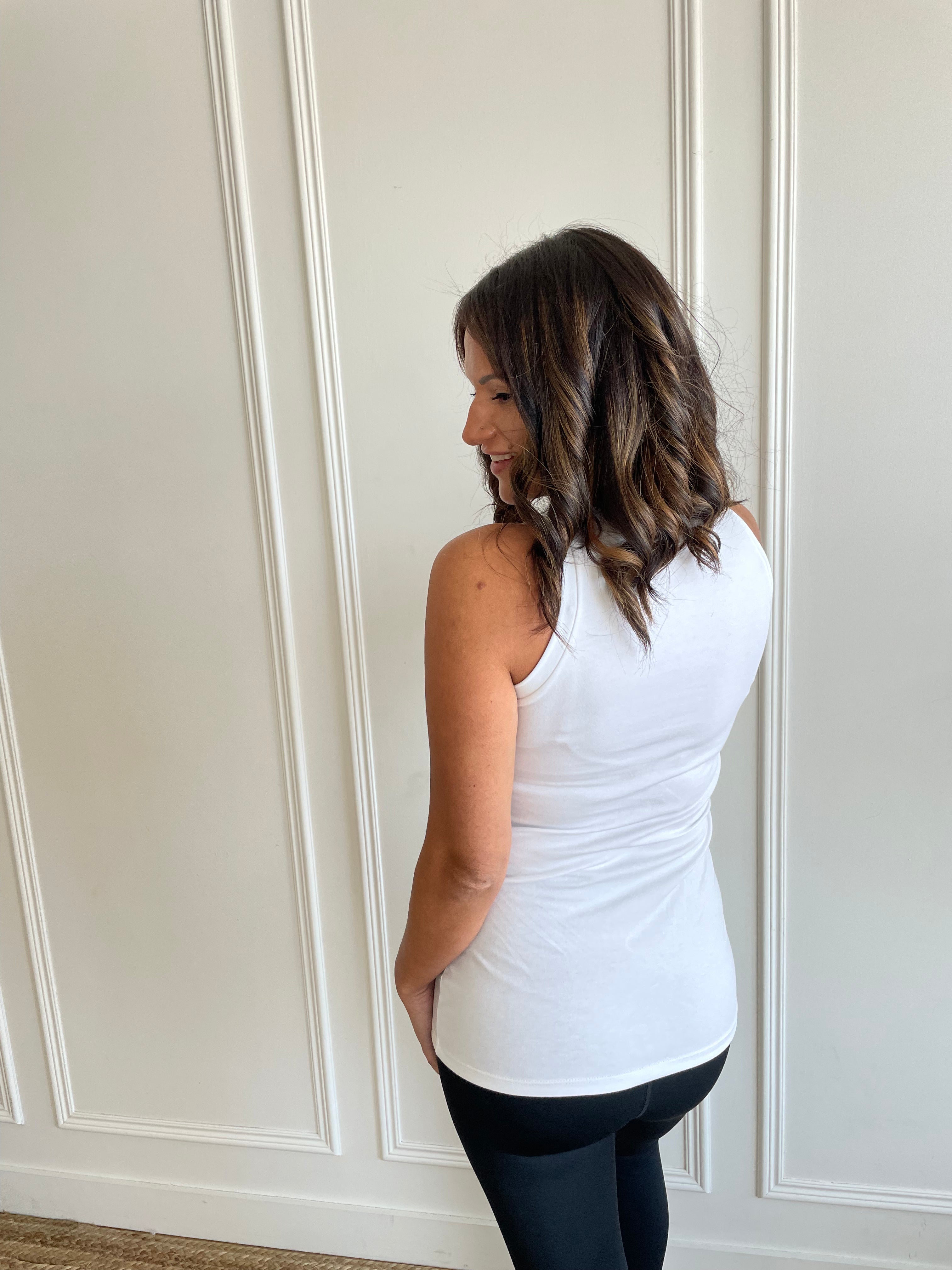 back view of woman wearing high neck white tank top