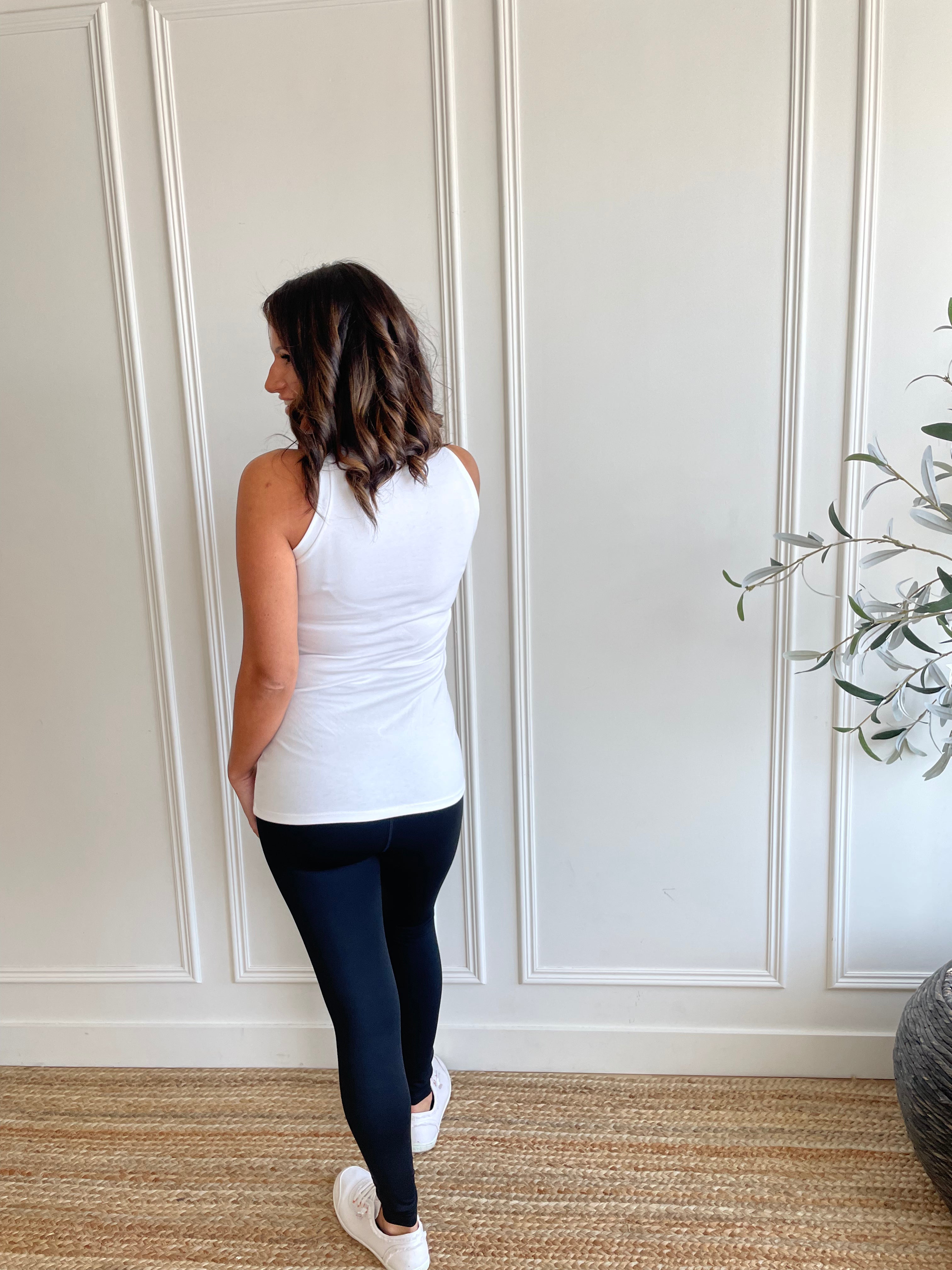 back view of white high neck tank top and leggings