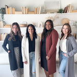 four women wearing long duster cardigan sweaters