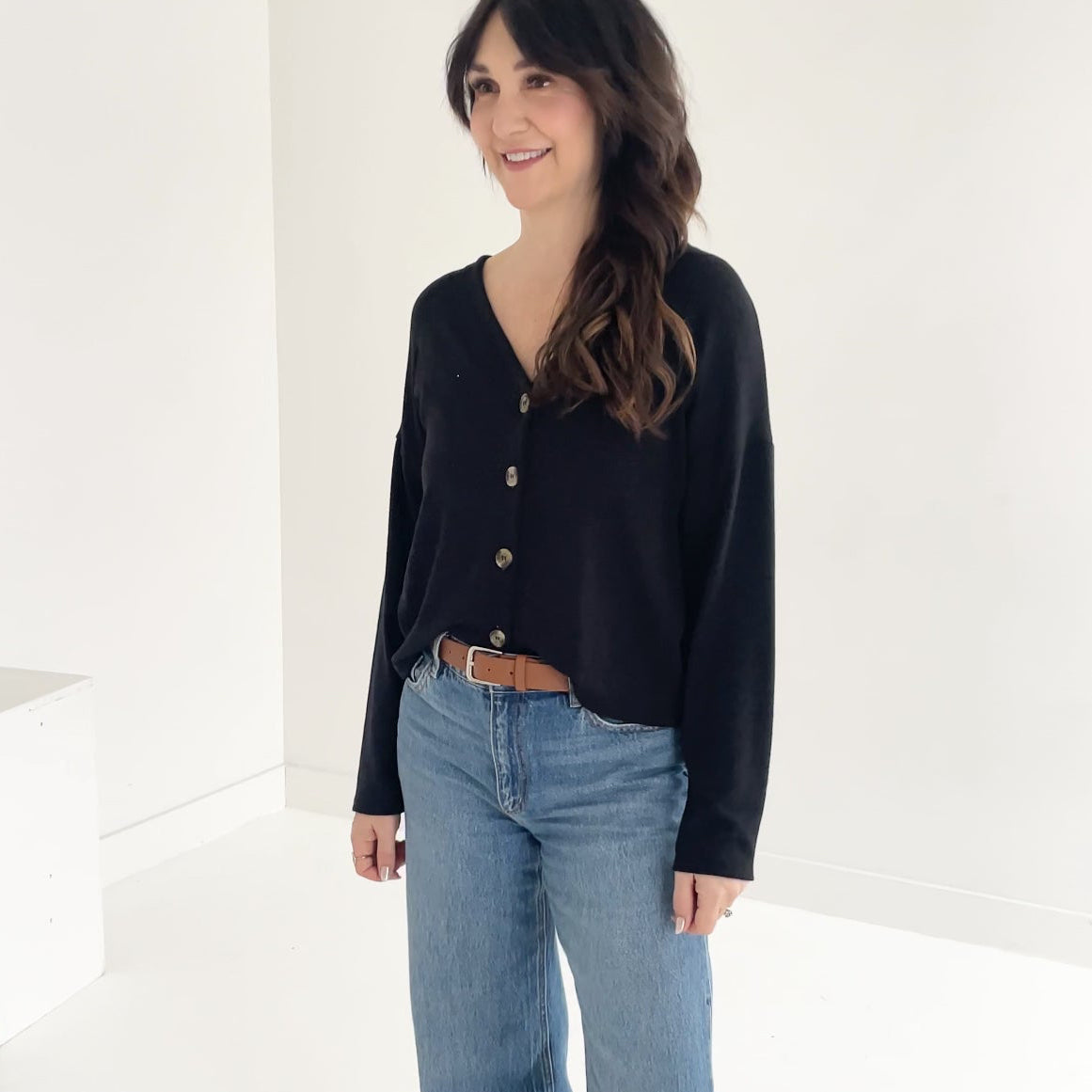 Model wearing black button up cardigan Canadian-made