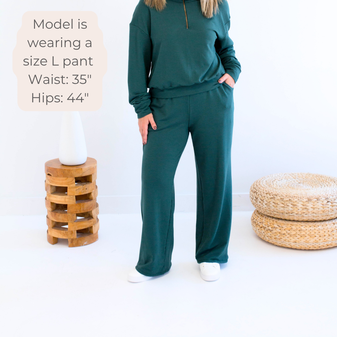 Ang Hill woman wearing dark green bamboo wide leg loungewear pants. Made in Canada