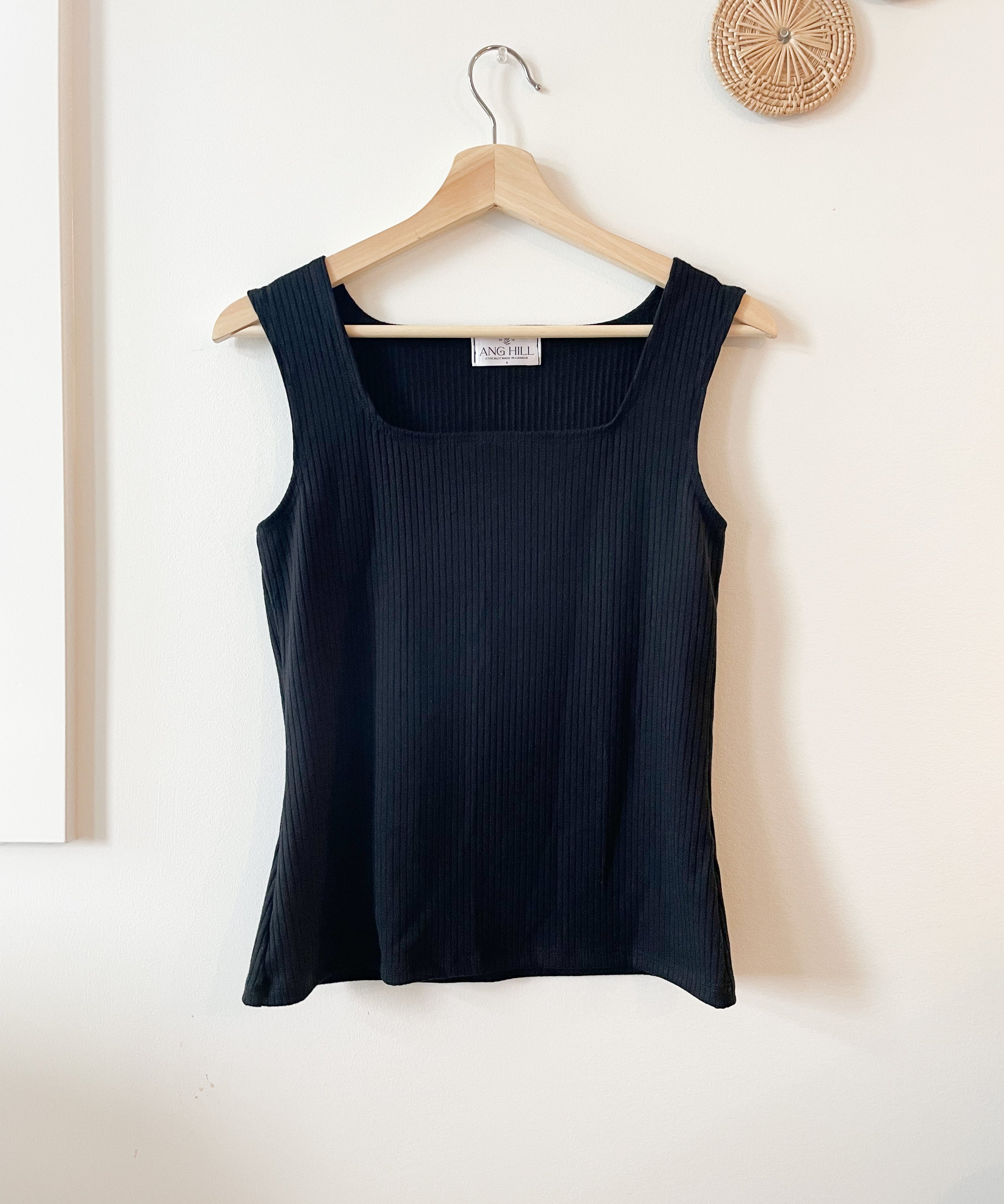 black square neck top hanging on hanger