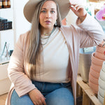 long pink cardigan, hat and jeans