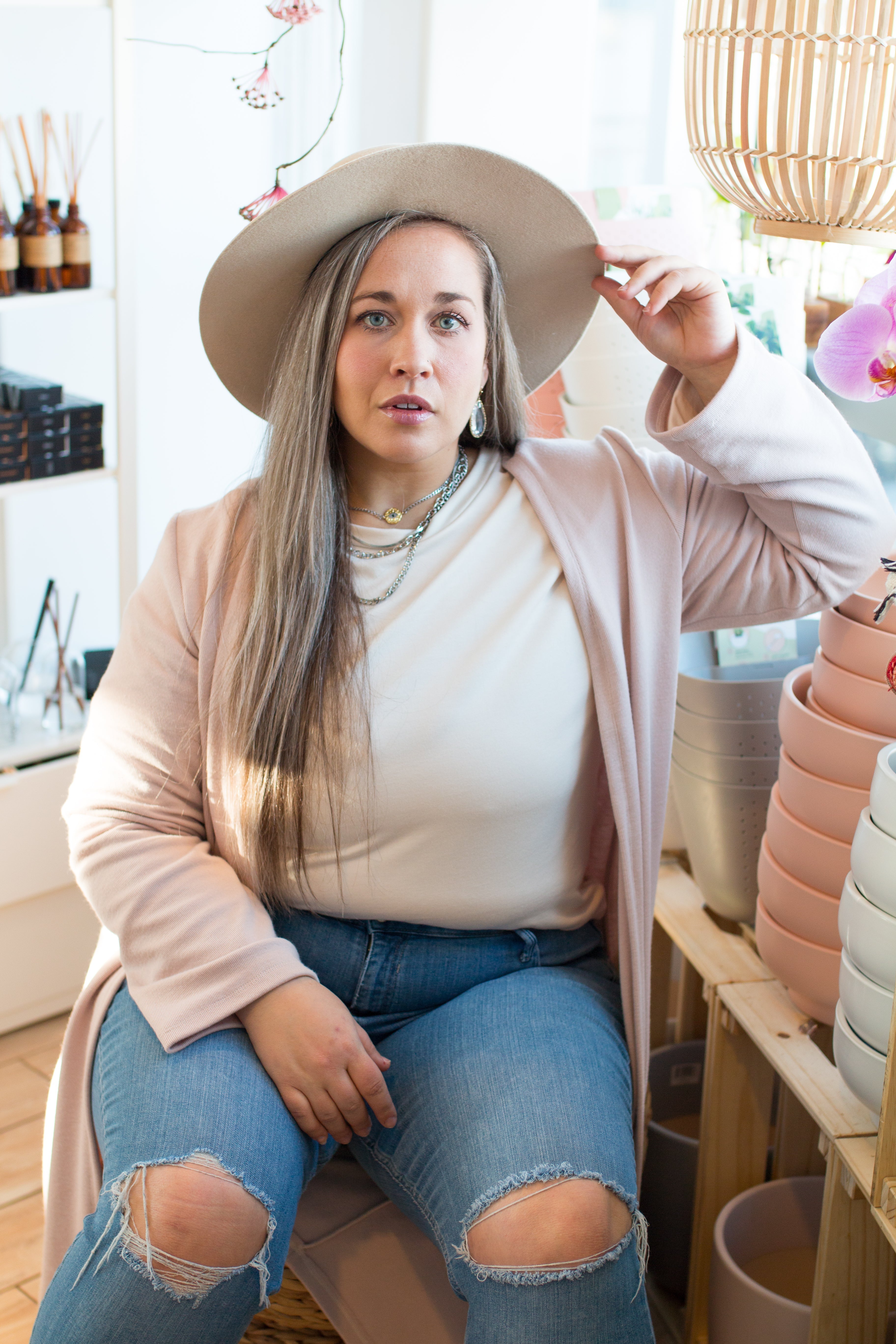 long pink cardigan, hat and jeans