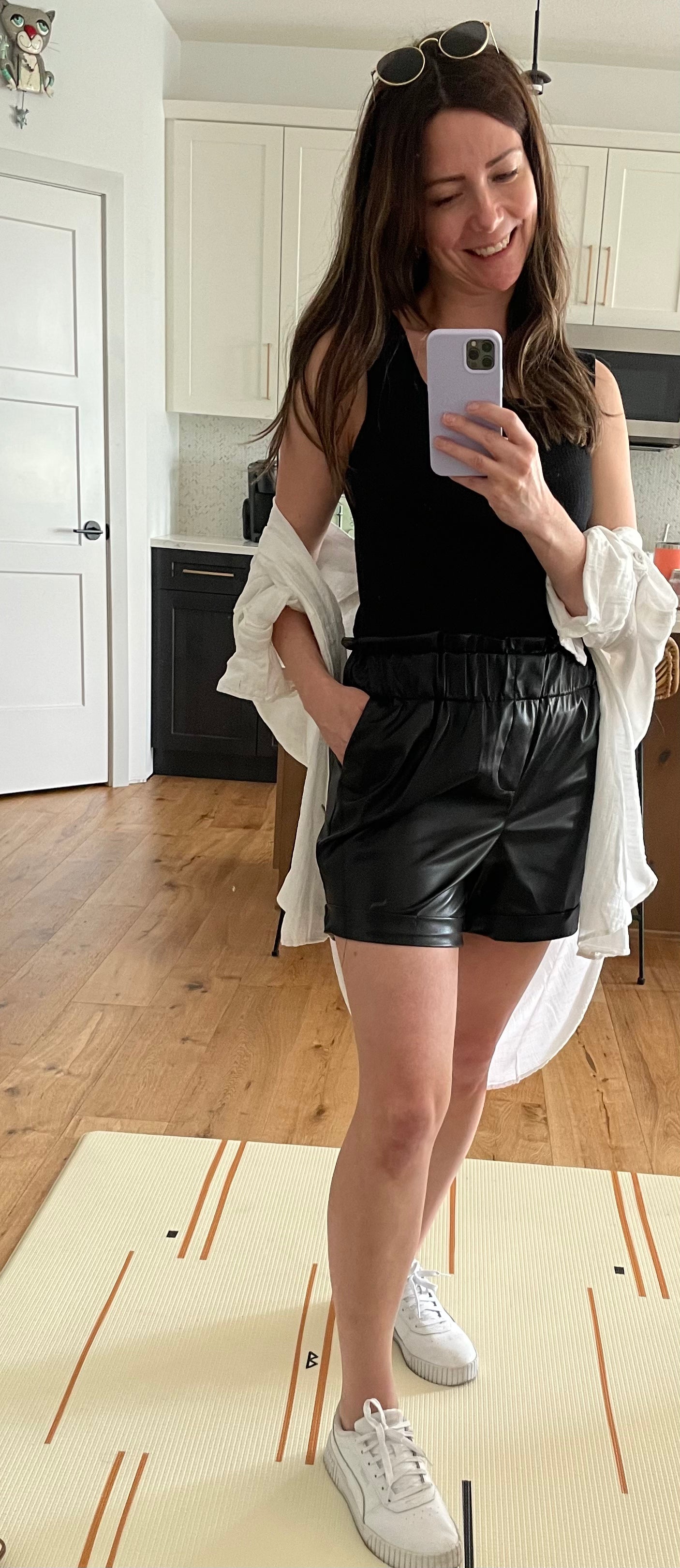 woman wearing square neck tank top and vegan leather paper bag shorts 