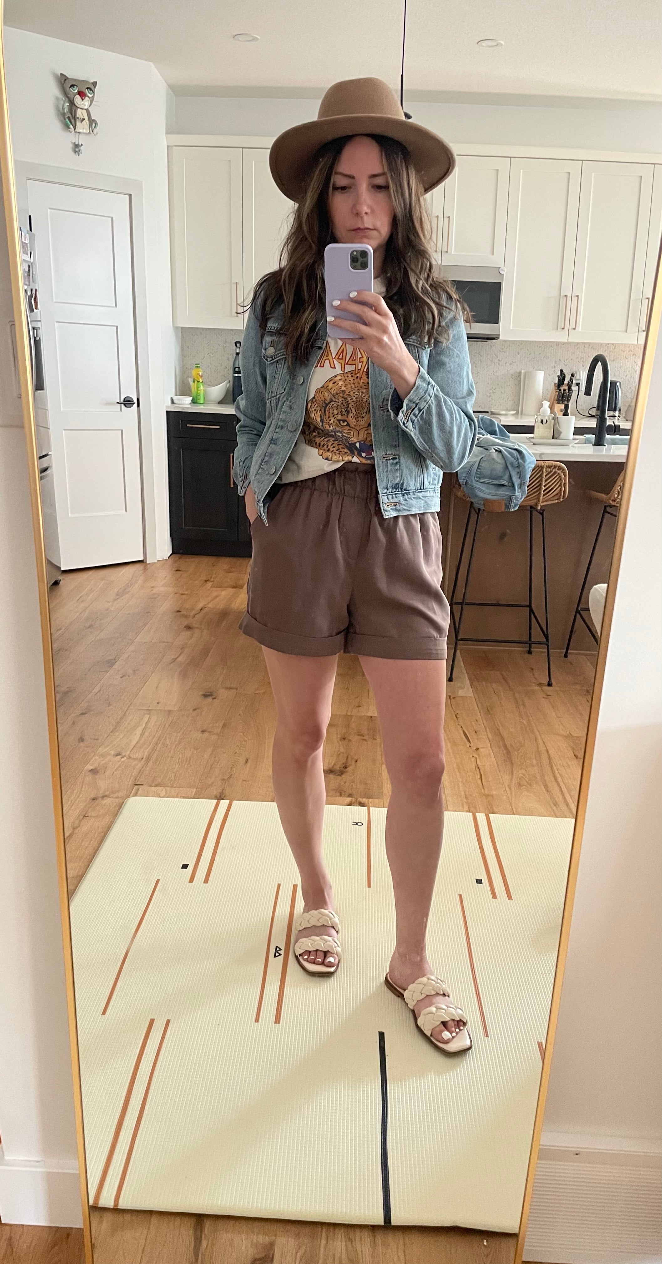 brown shorts, graphic tee and denim jacket