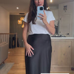 Woman wearing a white t-shirt and black satin maxi skirt video. Made in Canada
