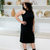 woman wearing hat and black midi tank dress and black booties