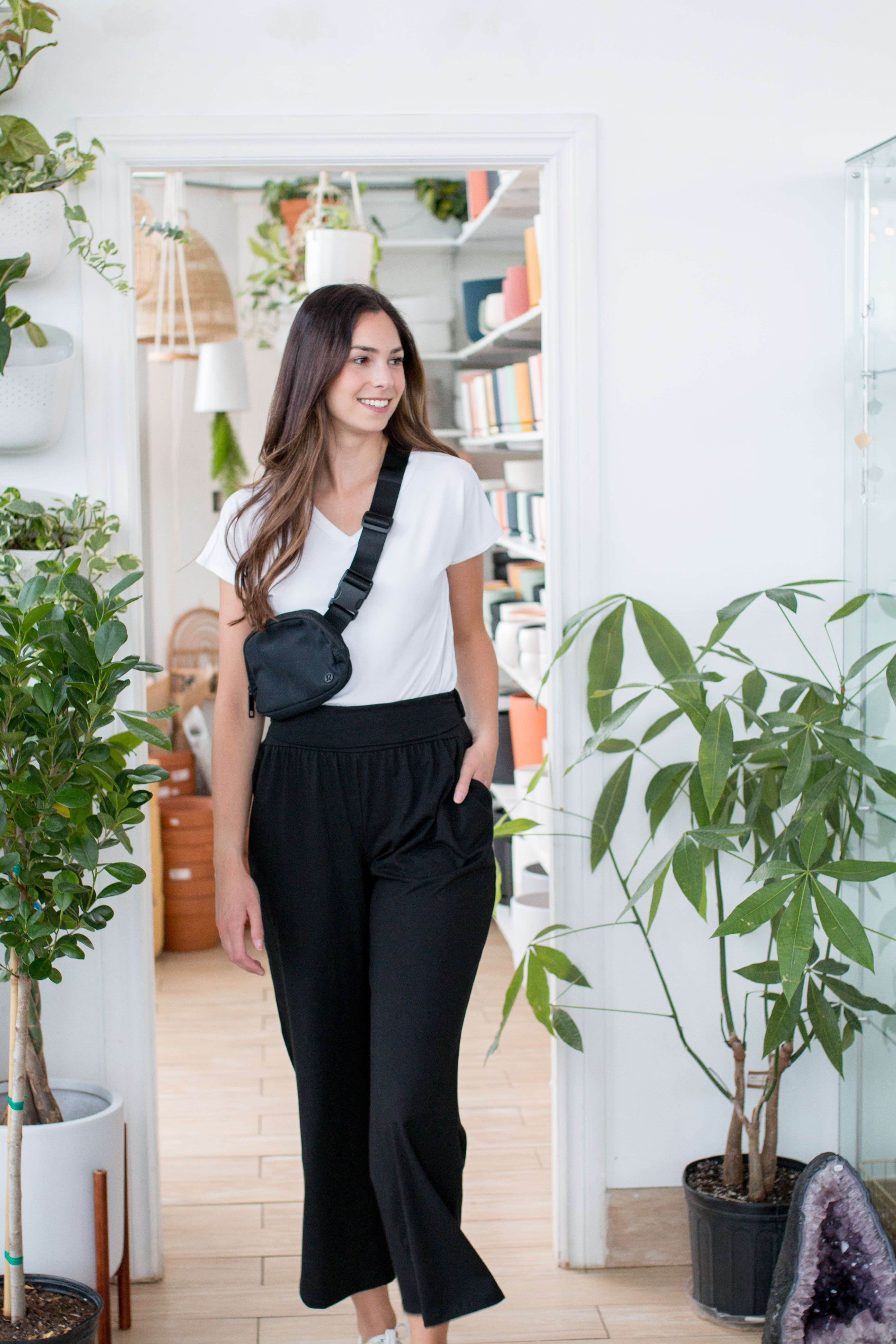 woman wearing white v-neck with black wide leg pants