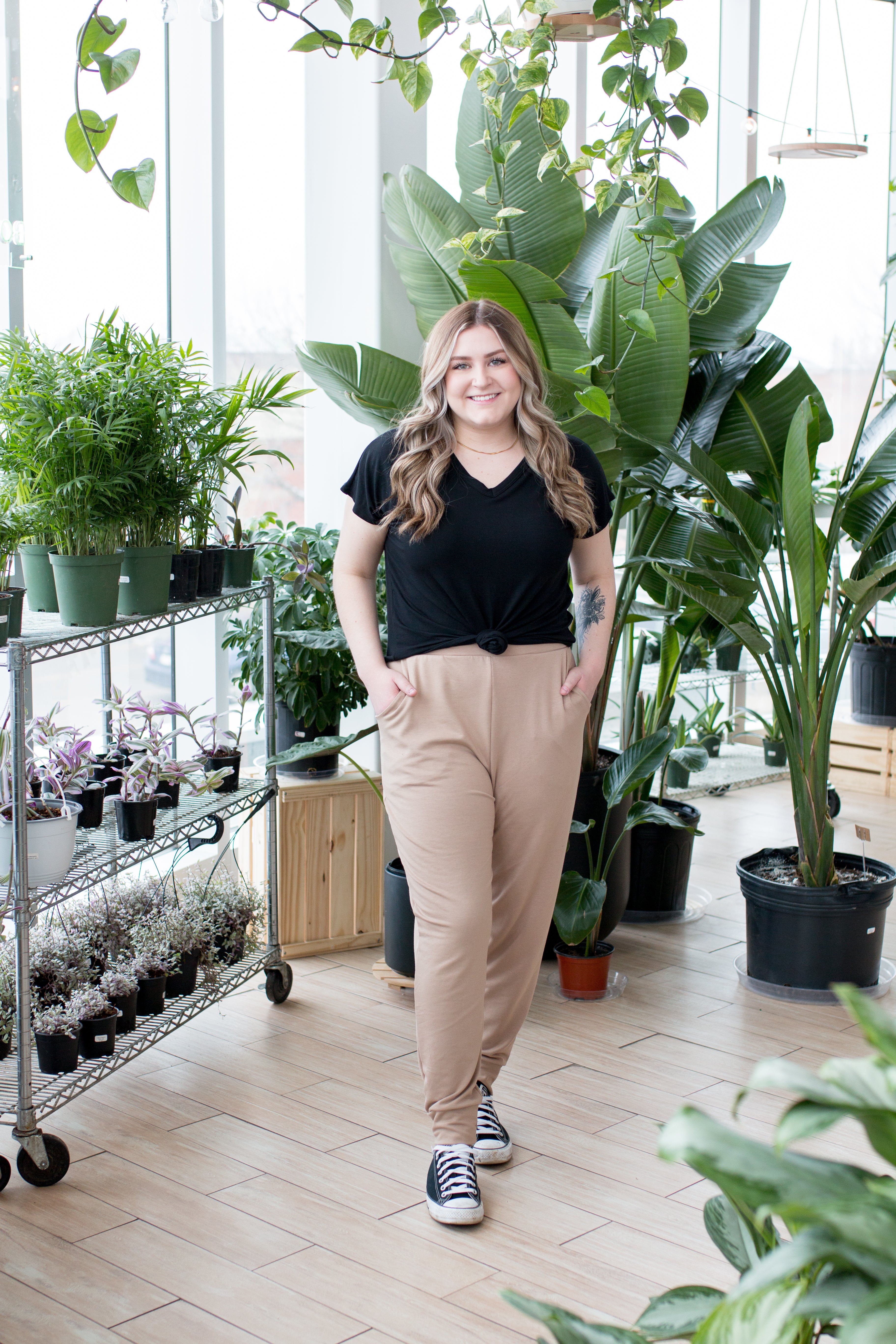 blonde woman sitting in black vneck t shirt and joggers